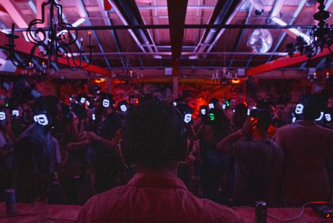Silent Disco Event – Flamingo House Nightlife Experience Midtown Sacramento DJ performing at Flamingo House silent disco with a packed crowd wearing glowing headphones under colorful lights in Midtown Sacramento